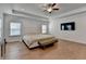 Spacious main bedroom with hardwood floors, a ceiling fan, and a king-size bed, perfect for relaxation and comfort at 4409 Encore Park Lane, Duluth, GA 30097