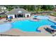 Bright blue pool featuring covered seating, lounge chairs, tables, and an open recreation space at 4409 Encore Park Lane, Duluth, GA 30097