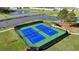 Two pristine tennis courts surrounded by lush landscaping and neighborhood residences at 4409 Encore Park Lane, Duluth, GA 30097