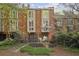 Exterior view of the rear of the home showcasing multi-story windows, brick facade, and landscaping at 45 Willow Ne Gln, Atlanta, GA 30342