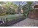 Lush backyard with mature trees, landscaped gardens, and a brick patio for outdoor enjoyment at 45 Willow Ne Gln, Atlanta, GA 30342