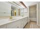 Well-lit bathroom with a double vanity, neutral tile, and a shower-tub combination at 45 Willow Ne Gln, Atlanta, GA 30342