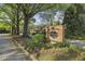 Charming community entrance sign with lush landscaping and mature trees at 45 Willow Ne Gln, Atlanta, GA 30342