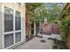 Private brick courtyard featuring mature trees and access to the home at 45 Willow Ne Gln, Atlanta, GA 30342