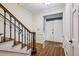Bright foyer with wood floors, stairway with dark iron balusters and a white front door with glass pane windows at 45 Willow Ne Gln, Atlanta, GA 30342