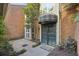Charming front entrance with brick patio and ornate wrought iron security door, sheltered by an awning at 45 Willow Ne Gln, Atlanta, GA 30342