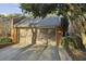 Exterior view of a two-car garage with a brown door, driveway and home address at 45 Willow Ne Gln, Atlanta, GA 30342