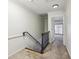 Hallway with carpeted floor and wooden handrail leading to the floor above at 45 Willow Ne Gln, Atlanta, GA 30342