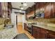 A well-lit kitchen with granite countertops, stainless steel appliances, and wood cabinets at 45 Willow Ne Gln, Atlanta, GA 30342