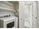 Bright laundry room features a modern washer and dryer, built in shelves and an open doorway at 45 Willow Ne Gln, Atlanta, GA 30342