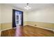 Living room featuring wood floors, soft yellow walls, and a large window with long, dark curtains at 45 Willow Ne Gln, Atlanta, GA 30342