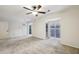 Open living room featuring plush carpeting, a ceiling fan, and a view of the outdoors at 45 Willow Ne Gln, Atlanta, GA 30342