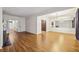 Spacious living room with wood floors, white trim and doorways, featuring a fireplace and large mirror wall at 45 Willow Ne Gln, Atlanta, GA 30342