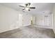 A large living room with gray carpet and three entry ways at 45 Willow Ne Gln, Atlanta, GA 30342