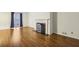 Bright living room featuring wood floors, fireplace, and a window with dark curtains at 45 Willow Ne Gln, Atlanta, GA 30342