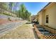 Professionally landscaped backyard with multi tiered retaining walls and lush greenery at 453 Thorn Creek Way, Dallas, GA 30157