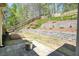 Professionally landscaped backyard with multi tiered retaining walls and lush greenery at 453 Thorn Creek Way, Dallas, GA 30157