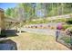 Professionally landscaped backyard with multi tiered retaining walls and lush greenery at 453 Thorn Creek Way, Dallas, GA 30157