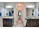 Dual-sink bathroom with dark wood cabinets, tile floors and view to the main bedroom at 453 Thorn Creek Way, Dallas, GA 30157