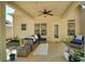 Inviting covered patio with comfortable seating, ceiling fan, and view of the backyard at 453 Thorn Creek Way, Dallas, GA 30157