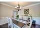 Formal dining room with elegant table set for six, stylish decor, and great natural light at 453 Thorn Creek Way, Dallas, GA 30157