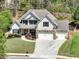 Beautiful home featuring a manicured lawn and three-car garage, nestled in a wooded neighborhood at 453 Thorn Creek Way, Dallas, GA 30157