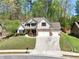 Beautiful home showcasing well-manicured lawn, three car garage, and inviting front entrance at 453 Thorn Creek Way, Dallas, GA 30157