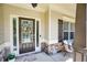 Charming front porch featuring a decorative wreath and stone accents by the front door at 453 Thorn Creek Way, Dallas, GA 30157