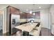 Modern kitchen featuring stainless steel appliances, a granite island, and dark wood cabinetry at 453 Thorn Creek Way, Dallas, GA 30157