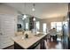 Bright, open kitchen featuring granite countertops, an island sink, and stainless steel appliances at 453 Thorn Creek Way, Dallas, GA 30157