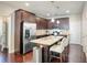 Modern kitchen featuring stainless steel appliances, a granite island, and dark wood cabinetry at 453 Thorn Creek Way, Dallas, GA 30157