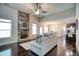 Open-concept living room with a stone fireplace, hardwood floors, and plenty of natural light at 453 Thorn Creek Way, Dallas, GA 30157