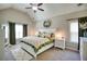 Vaulted primary bedroom featuring a plush bed, carpeted floors, and bright windows at 453 Thorn Creek Way, Dallas, GA 30157
