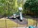 Fenced playground area featuring climbing structure and slides for outdoor fun and entertainment at 453 Thorn Creek Way, Dallas, GA 30157