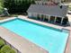 Community pool and pool house with covered seating offering a place to relax in the shade at 453 Thorn Creek Way, Dallas, GA 30157
