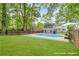 Expansive backyard with lush lawn, mature trees, and an in-ground pool. Concept Only. Virtual rendering at 60 Spence Se Ave, Atlanta, GA 30317