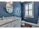 Bathroom featuring blue walls, white cabinets, and a marble countertop at 60 Spence Se Ave, Atlanta, GA 30317