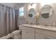 Well-lit bathroom featuring a dual-sink vanity, toilet, and a shower with stylish fixtures and finishes at 60 Spence Se Ave, Atlanta, GA 30317