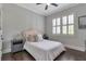 Bedroom features gray walls, a ceiling fan, and a large window for natural light at 60 Spence Se Ave, Atlanta, GA 30317