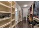 Spacious walk-in closet offering ample storage with built-in shelving and racks, with a view to the bathroom at 60 Spence Se Ave, Atlanta, GA 30317