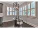 The dining area has wood floors, a metal chandelier, and many windows letting in natural light at 60 Spence Se Ave, Atlanta, GA 30317