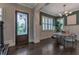 Elegant dining area featuring a modern chandelier, large windows with shutters, and hardwood floors at 60 Spence Se Ave, Atlanta, GA 30317