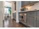Kitchen area features stainless steel microwave and oven along with gray cabinetry at 60 Spence Se Ave, Atlanta, GA 30317