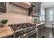 This kitchen features a stainless steel stove with granite countertops and a subway tile backsplash at 60 Spence Se Ave, Atlanta, GA 30317
