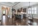 Open-concept kitchen with stainless steel appliances, a breakfast bar, and hardwood floors at 60 Spence Se Ave, Atlanta, GA 30317