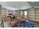 Bright home office with custom bookshelves, modern desk setup, and comfortable seating area, ideal for remote work at 60 Spence Se Ave, Atlanta, GA 30317