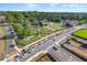 Aerial view of a park, landscaping, and green space, with trees, roads, and sidewalks under a sunny sky at 216 Ellis Ln, Woodstock, GA 30189