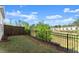 Backyard with a lush lawn and a black metal fence at 216 Ellis Ln, Woodstock, GA 30189