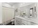 Well-lit bathroom with double sinks, white cabinets, and a shower-tub at 216 Ellis Ln, Woodstock, GA 30189
