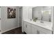 Bright bathroom with double sinks, a modern white vanity, and tile flooring at 216 Ellis Ln, Woodstock, GA 30189